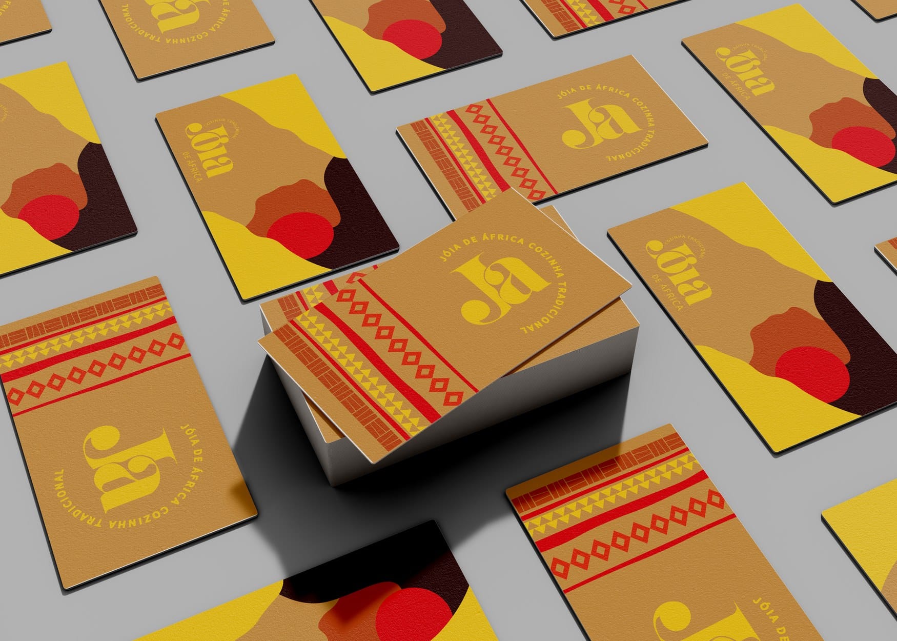 Business cards scattered on a grey surface, both sides visible