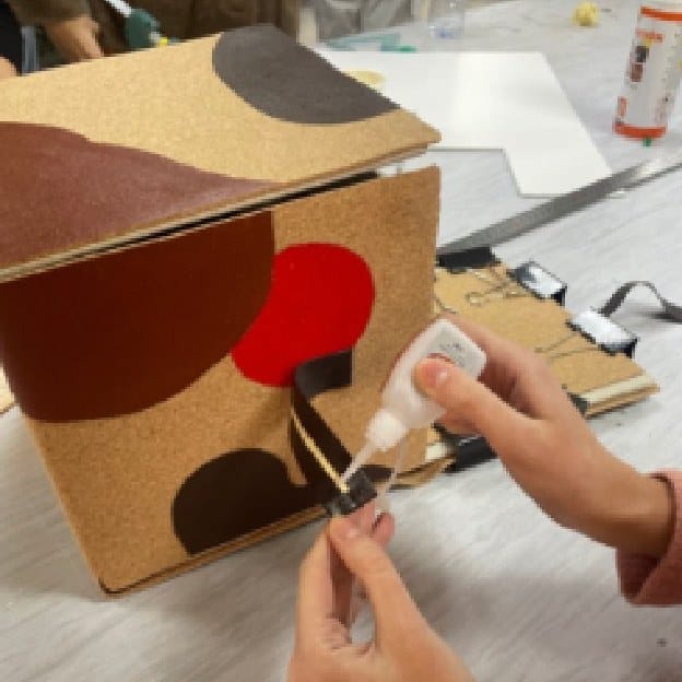 Gluing a strap onto the painted box