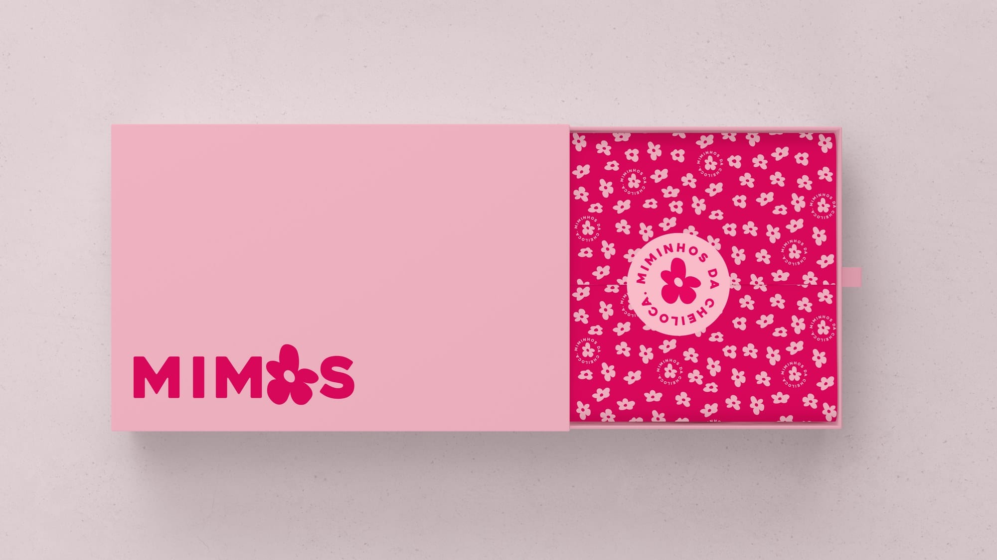 Pink shoe box with the Mimos wordmark and a patterned sleeve